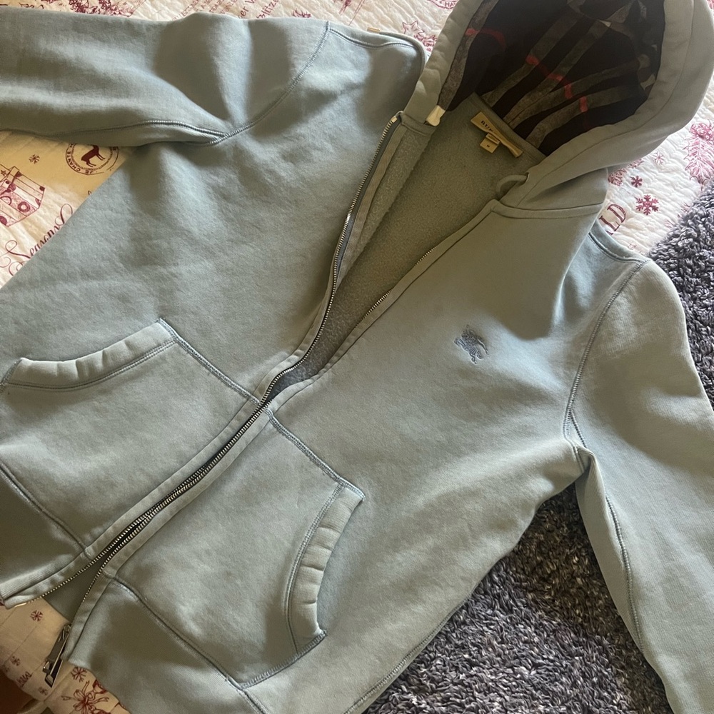 Light blue-ish/light grey Burberry hoodie.  Size M.  Very used condition